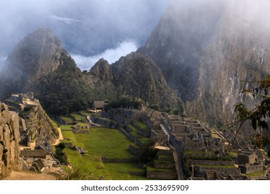 A breathtaking view of Machu Picchu, the ancient Incan citadel in Peru, surrounded by misty mountains and lush greenery. - Powered by Shutterstock