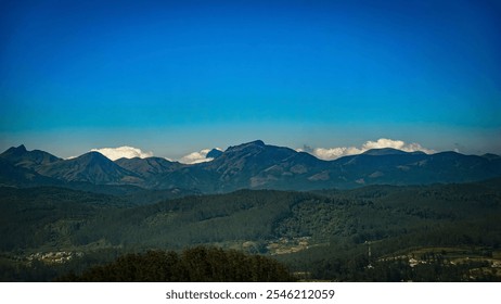 A breathtaking view of a majestic mountain range with a clear blue sky. The lush green valleys and rolling hills add to the scenic beauty of this picturesque landscape. - Powered by Shutterstock