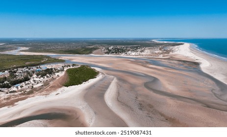 Breathtaking view of the Morondava Coast in Madagascar, featuring winding rivers and expansive sandy shores under a clear blue sky - Powered by Shutterstock