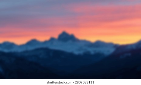 A breathtaking view of a mountain range silhouetted against a colorful sunset, showcasing the beauty of nature at dusk.