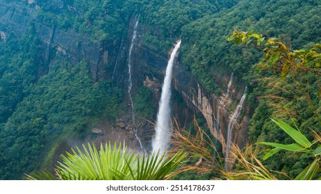 Breathtaking view of Nohkalikai Waterfalls, plunging from towering cliffs into lush greenery, Meghalaya, India. One of the tallest waterfalls in India. - Powered by Shutterstock