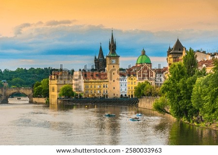 A breathtaking view from Old Town Square toward Charles Bridge in Prague, capturing the Vltava River, the Old Town Water Tower with its clock, the Klementinum, and the church of St. Francis of Assisi