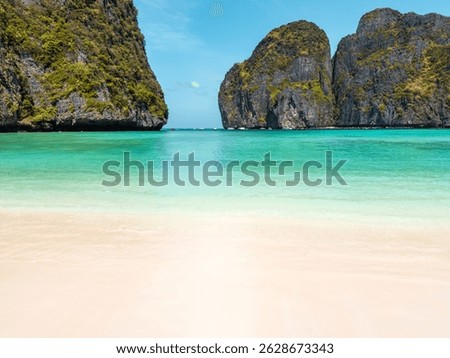 Breathtaking view of pristine white sand beach and turquoise waters with limestone cliffs at Maya Bay, Phi Phi Islands, Thailand, concept for exotic travel, summer holidays, high quality promo use.