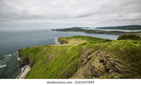 A breathtaking view of a steep cliff that overlooks a vast body of water