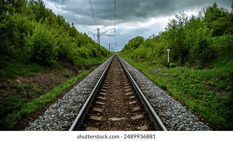 Breathtaking view of train tracks extending towards distant horizon, offering dramatic perspective