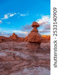 A breathtaking view of unique rock formations at Goblin Valley State Park in Utah, showcasing striking sandstone landscapes under a vibrant blue sky.