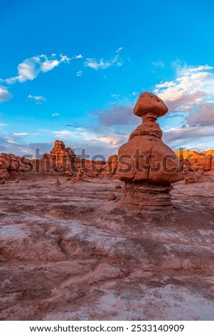 A breathtaking view of unique rock formations at Goblin Valley State Park in Utah, showcasing striking sandstone landscapes under a vibrant blue sky.