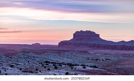 Breathtaking view of the Utah desert at sunset, showcasing dramatic hues and stunning rock formations under a colorful sky. - Powered by Shutterstock