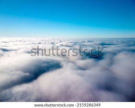 A breathtaking view of white fluffy clouds and a clear blue sky