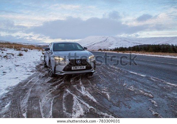 Brecon Beacons, UK: December 28, 2017: A Lexus NX 300h\
F-Sport crossover hybrid car on the road side in snow and dangerous\
icy conditions. 