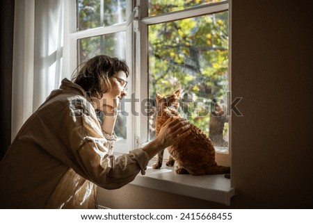 Similar – Image, Stock Photo Girl caressing adorable cat on couch