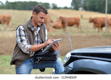 Breeder in farm using digital tablet - Powered by Shutterstock