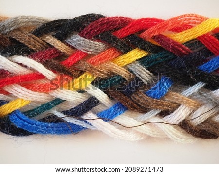 Breided thread plait with many different colours useful as a background