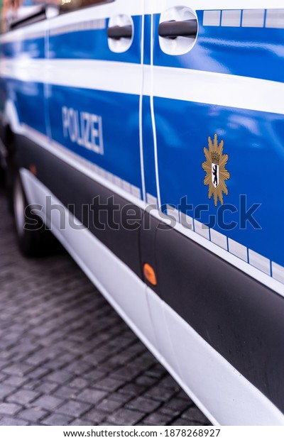 Bremen, Germany-05.12.20: Blue police car on the\
side of a political rally or demonstration. The badge of the german\
\
