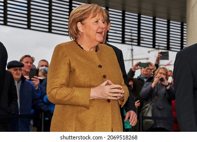 Bremerhaven, Germany - November 04, 2021: the German chancellor Angela Merkel stands outside the museum "Deutsches Auswandererhaus" in front of a crowd of curious people