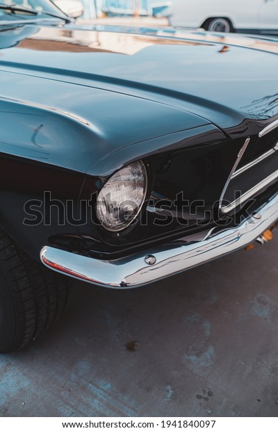 Brentford, West London | UK -  2021.03.21: First\
gneration black vintage Ford Mustang parked at the Brentford\
Projekt parking