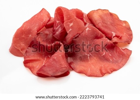 Bresaola slices isolated on white, italian dried beef salami from Valtellina