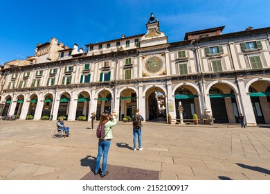 BRESCIA, ITALY - APRIL 17, 2022: Brescia downtown. Clock and bell tower in Renaissance style, 1540-1550, in Loggia town square (Piazza della Loggia). Lombardy, Italy, Europe. Astronomical clock.