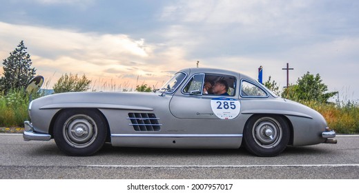 Brescia, Italy - June 16, 2021: A Vintage 1954 Mercedes Benz 300 SL Gullwing Coupe, With Veteran Formula 1 Driver Jochen Mass, On The Route From Brescia, Italy To Rome In The 2021 Mille Miglia.