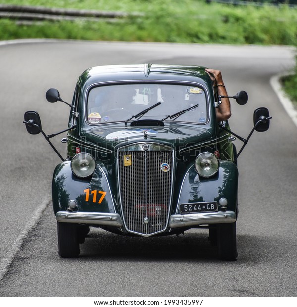 Brescia,
Italy - June 16, 2021: A vintage 1940 Lancia automobile rolls along
Italian roads at the 2021 Mille Miglia, a 100-mile re-creation of
the historic race from Brescia to Rome and
back.