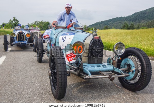 Brescia,\
Italy - June 16, 2021: A vintage 1928 Bugatti roadster rolls along\
Italian roads at the 2021 Mille Miglia, a 100-mile re-creation of\
the historic race from Brescia to Rome and\
back.