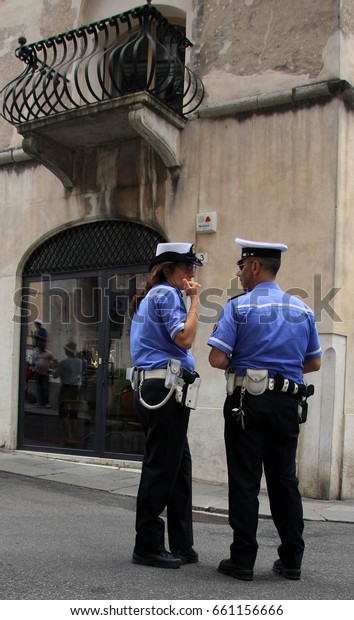 Brescia/Italy - May 18, 2017: Two Italian Police\
officers, one man, one woman\
talking