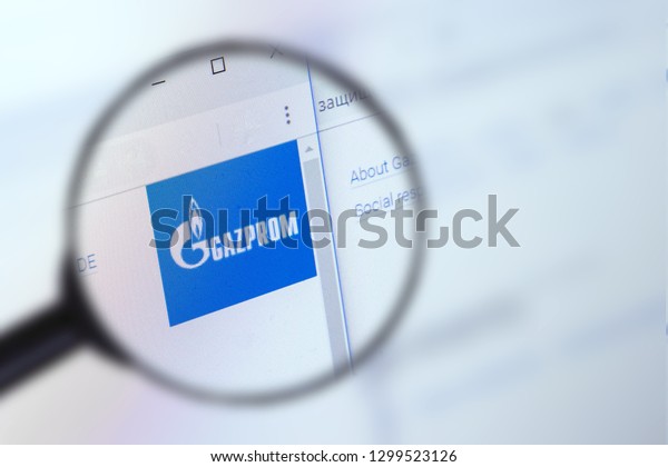 Brest, Belarus, January 22, 2019. The main page of the site Gazprom, view through a magnifying glass. Gazprom logo company visible. Soft focus.