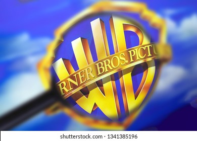 Brest, Belarus, March 15, 2019. The Home Page Of The Warner Brothers Website, View Through A Magnifying Glass. Warner Brothers Company Logo Is Visible. Soft Focus.