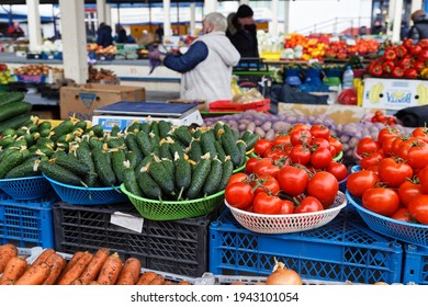 Brest, Belarus - March 25, 2021: Fresh cucumbers and tomatoes at the agricultural market in Brest. 
