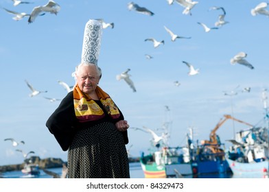 breton women with headdress and seagull on a harbor