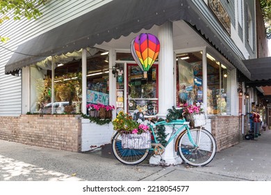 BREVARD, NORTH CAROLINA, USA-9 OCTOBER 2022: O. P. Taylor's Toy Store, Showing Exterior Corner Entrance With Flower-covered Bicycle On Display.