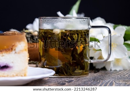 Brewed green tea with jasmine on the table, dried tea leaf for brewing green tea with jasmine flavor