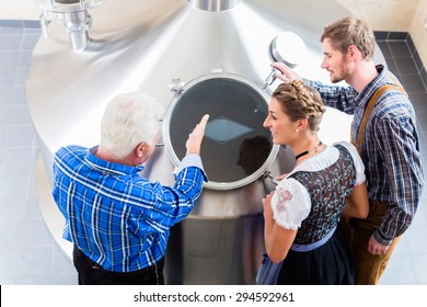 Brewer And Couple In Beer Brewery Guided Tour