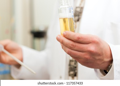 Brewer in the laboratory of his brewery and is doing analysis - Powered by Shutterstock