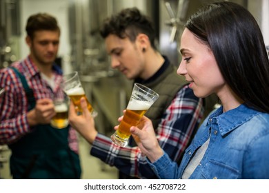 Brewers testing beer at brewery factory - Powered by Shutterstock