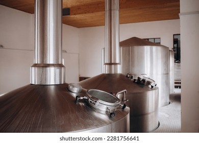 Brewery equipment. Brew manufacturing. Round cooper storage tanks for beer fermentation and maturation. - Powered by Shutterstock