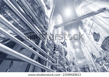 Brewery food industrial production concept. Large reservoirs or tanks in modern beer factory, Pipes stainless steel brewing equipment.