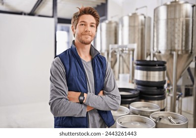 Brewery, man and portrait with arms crossed in factory with confidence, pride and container machine for manufacturing. Industrial, worker and smile in distillery with tank for brewing in warehouse - Powered by Shutterstock