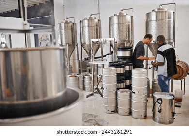 Brewery, production and people with steel in factory or distillery for winery, alcohol and drink manufacturing. Worker or winemaker checking metal tank, container or fermentation vessel for beer - Powered by Shutterstock