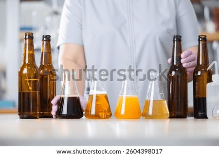 Brewery science: analyzing beer samples in laboratory setting. Concept banner control quality of drink food.