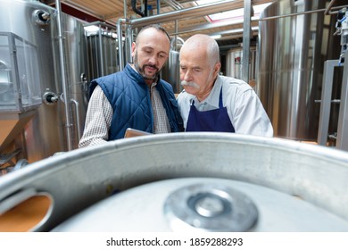 brewery workers looking at the data - Powered by Shutterstock