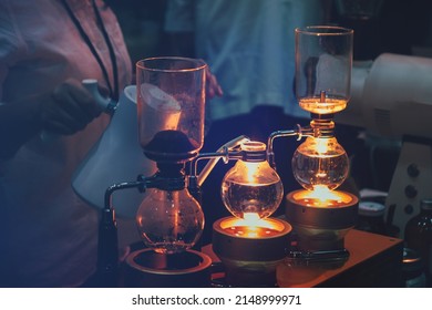 Brewing coffee by siphon method.