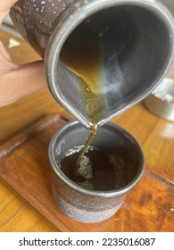 brewing coffee from a ceramic pitcher