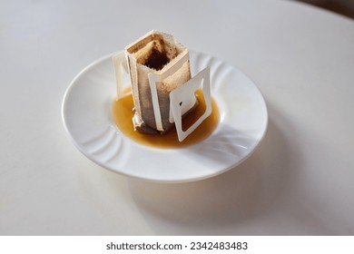 brewing process,a bag filled with boiling water for drip coffee in a cup,top view