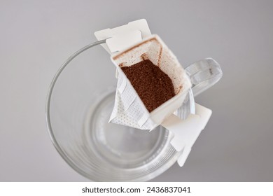 brewing process,a bag filled with boiling water for drip coffee in a cup,top view