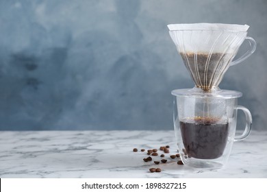 Brewing Tasty Coffee Using Drip Filter On White Marble Table. Space For Text