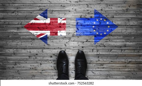 Brexit, flags of the United Kingdom and the European Union on wooden background with legs and shoes