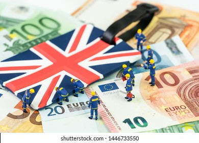 Brexit Negotiation Plan Or Euro Zone Withdrawal Concept, Miniature Figures Worker Help Move UK Union Jack Flag From Pile Of Euro Banknotes Money.