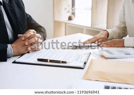 Bribery and corruption concept, bribe in the form of dollar bills, Businessman giving money in the envelope while making deal to agreement a real estate contract and financial corporate.