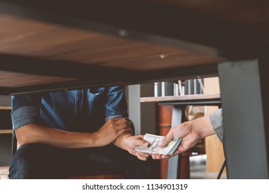 Bribery, Hands Passing Money Under Table, Corruption And Bribery Concepts.